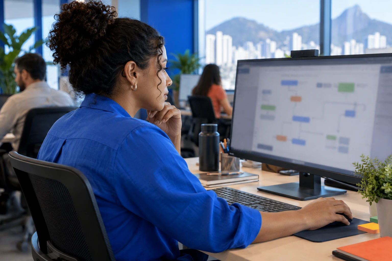 uma profissional organizando um fluxo de trabalho em seu computador.